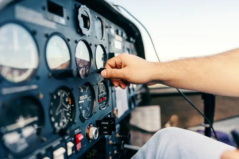 Pilot's hand on the controls in an aircraft cockpit